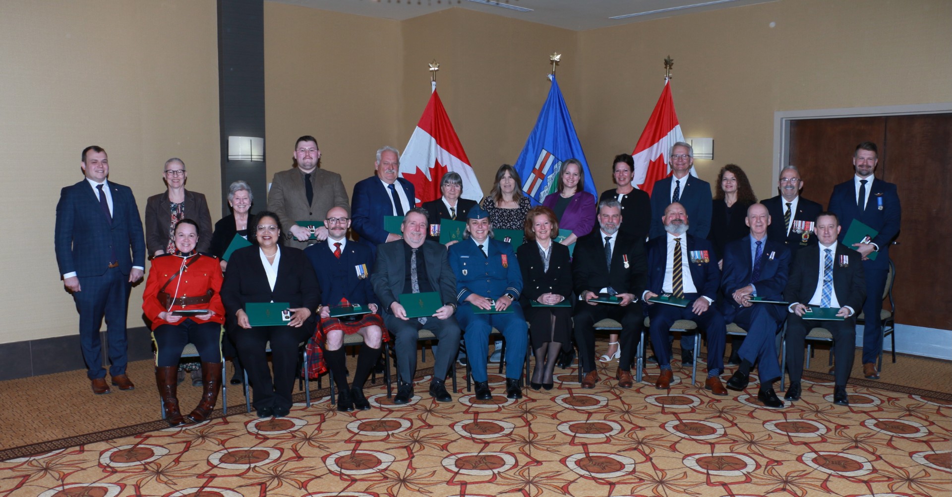 Group of people sitting and standing for a group photo