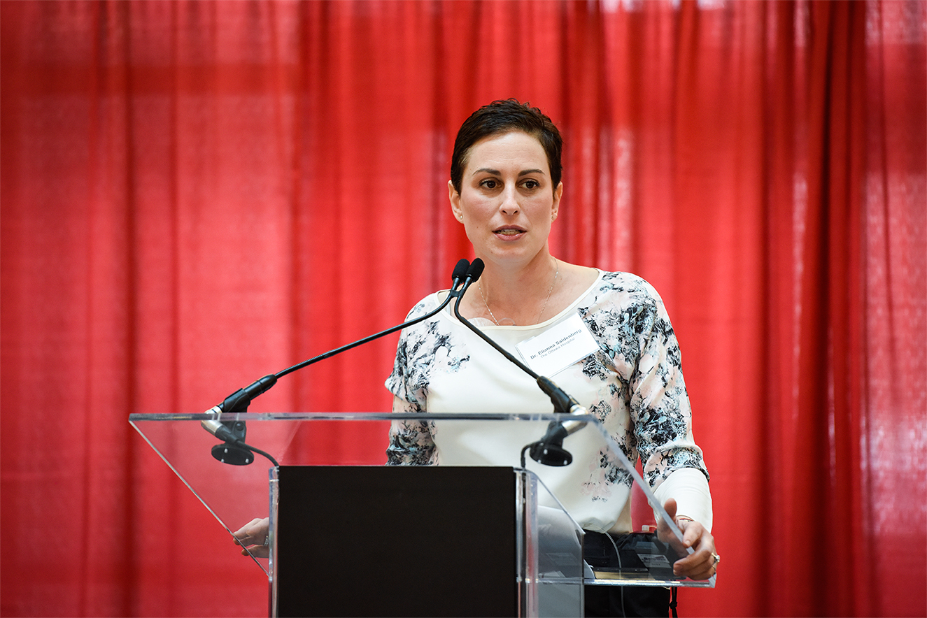 A woman speaking at a podium