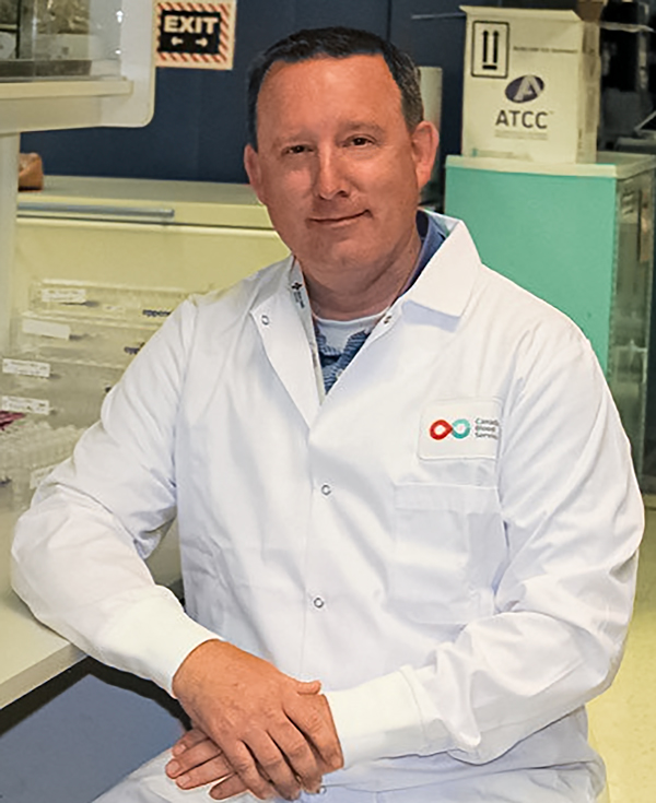 Image of Researcher Dr. Jason Acker sitting in the lab at Canadian Blood Services’ Centre for Innovation