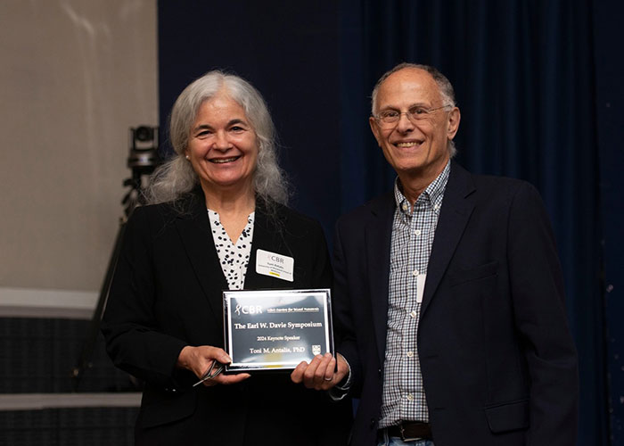 Two people holding an award