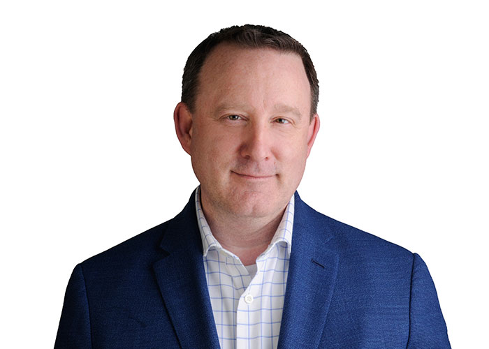 Jason Acker wearing a blue striped white shirt and a blue blazer