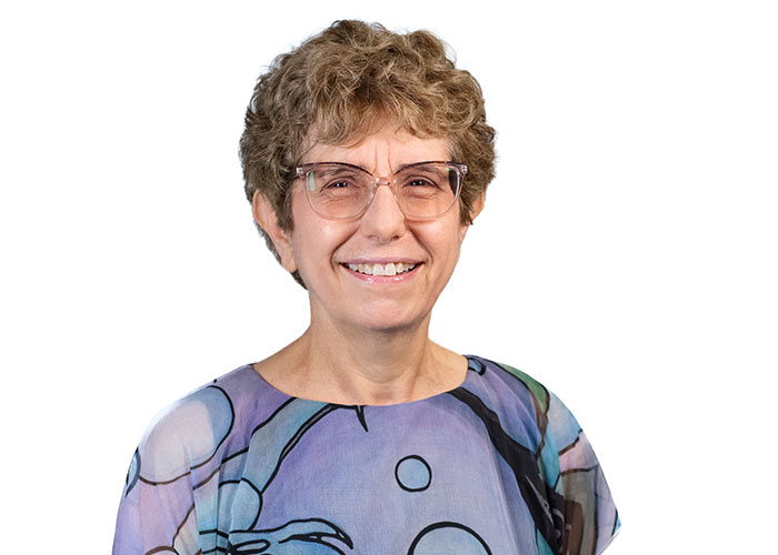 Mindy Goldman wearing a purple with bubbles shirt