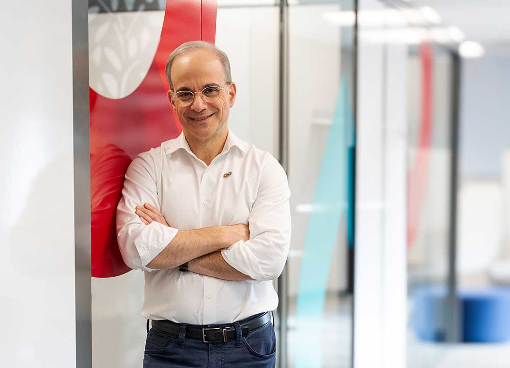 Dr. Zimring, standing in a Canadian Blood Services’ hallway, smiling with his arms crossed.