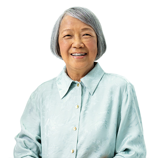 Wai Yin, wearing a light blue button up shirt, looking at the camera smiling