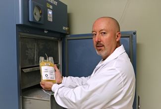 Image of Craig holding frozen plasma.