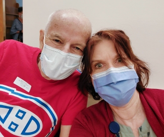 Father wearing hockey jersey with adult daughter