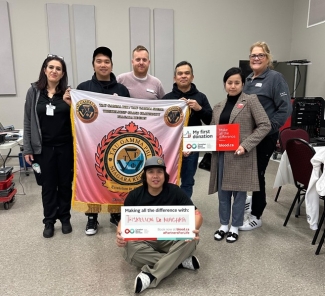 Group of first time blood donors holding signs