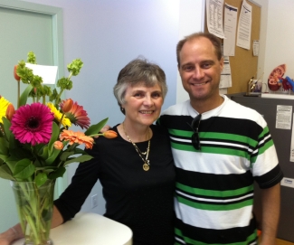 Mother and adult son with flowers indoors