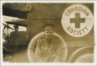 L. Bruce Robertson beside Canadian Red Cross truck, ca. [1914-1918]  Copyright: Queen’s Printer for Ontario