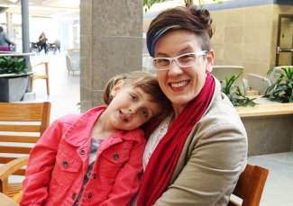 Leah Hunt and daughter Fiona sitting on a bench inside