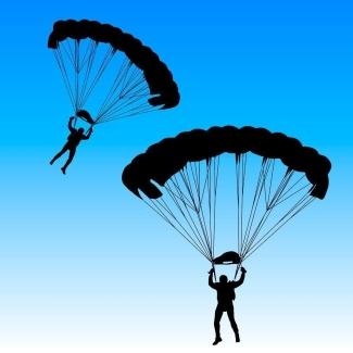 Image of two parachuters jumping at night