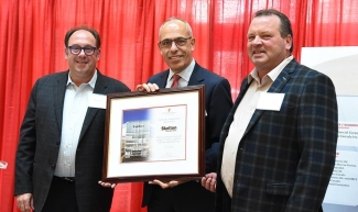 Mike Skelton, and Ron Skelton Graham Sher holding up an award for Skelton Truck Lines at the 8th Annual Corporate Supporters’ Luncheon