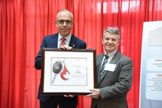 Tony Kelly and Graham Sher holding up an award for Toyota Canada at the 8th Annual Corporate Supporters’ Luncheon