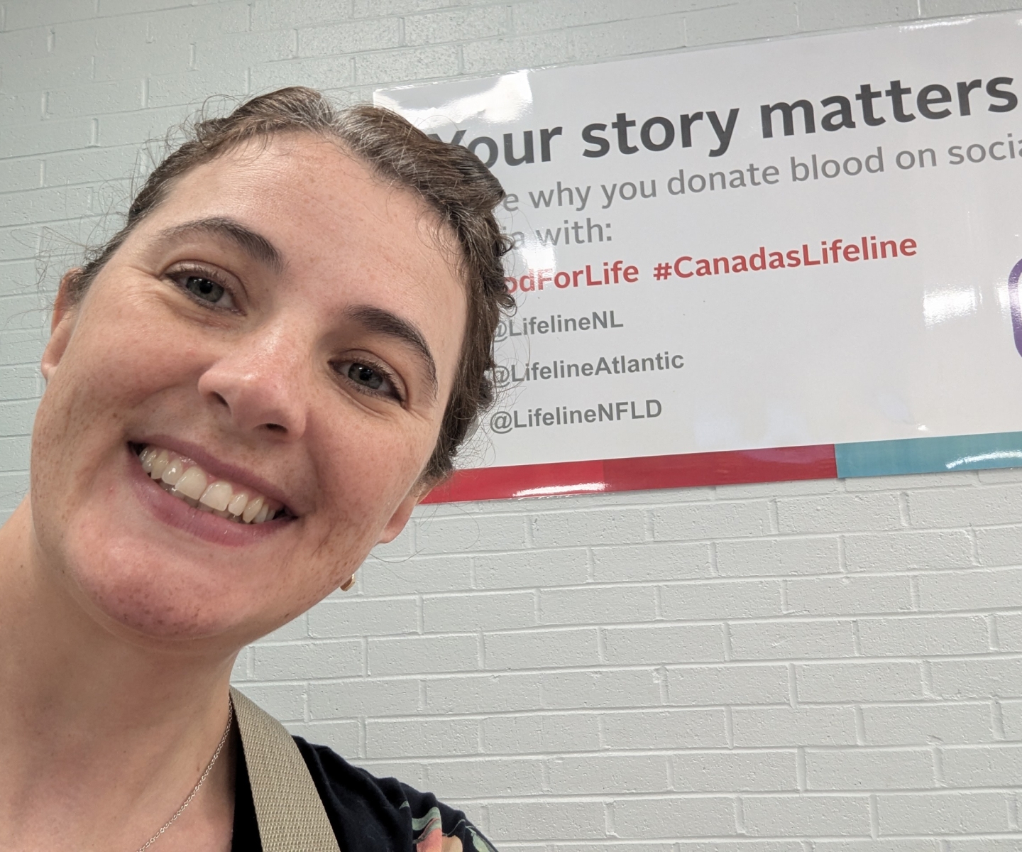 Blood donor with sign that says Your story matters