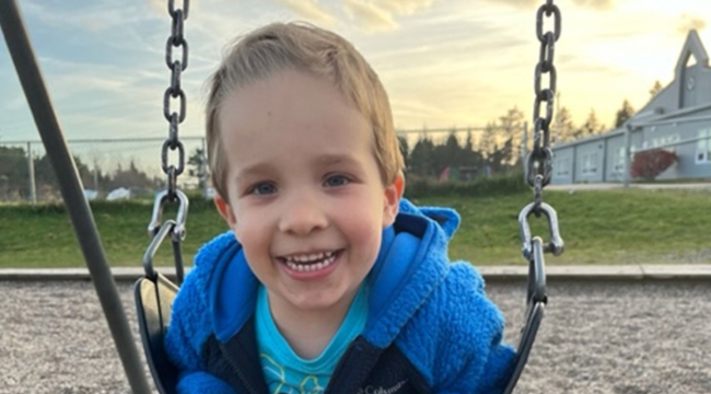 Colton Burns on a swing at the play structure