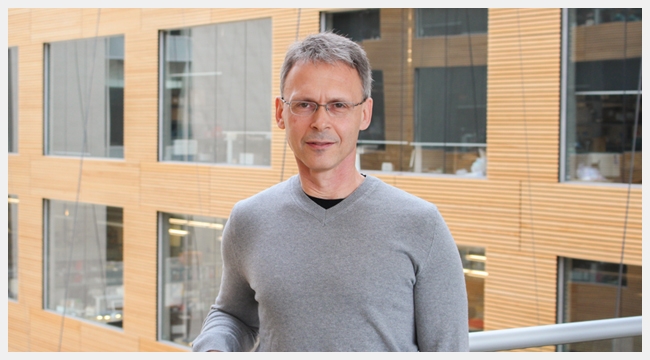 Image of Ed Pryzdial wearing a grey shirt and glasses at the Canadian Blood Services Head Office location