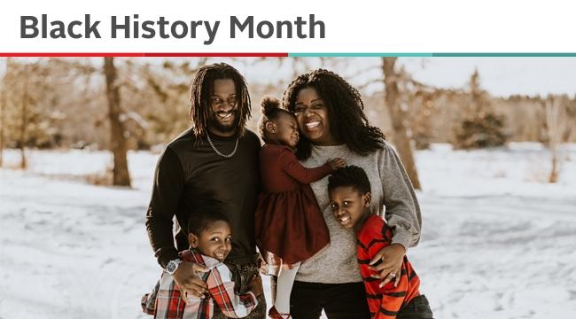 A child who had blood transfusions is held by her parents who are blood donors, as they pose for a photo outside in winter with the child’s two brothers. 