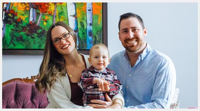 Thumbnail image of blood donor and a registered organ donor Greg Kitchen along with wife Deanna Kitchen and son Cole Kitchen sitting on the sofa in front of a painting in their house.