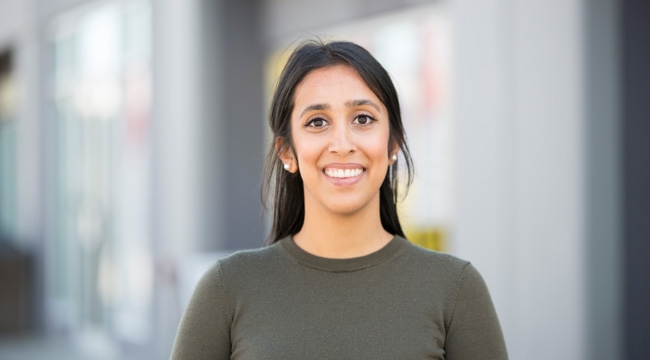 Jastej Sidhu, an Adult woman stands outside in front of a storefront