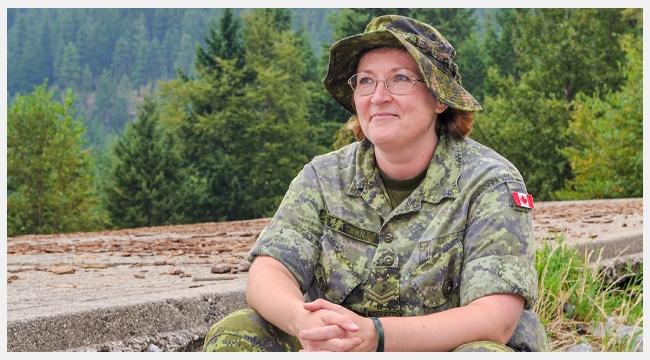 Image of blood donor Corporal Laura Matern sitting on a rock wearing full military uniform