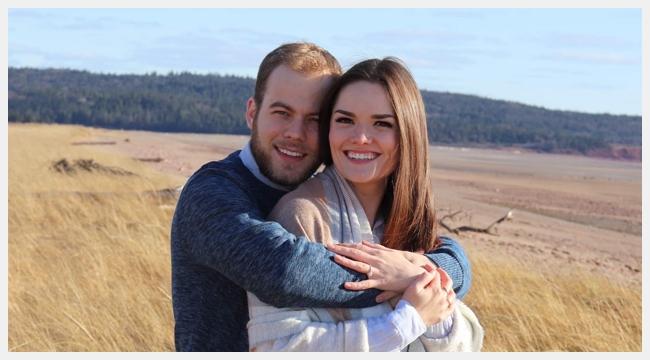 Lizzy Burns and her fiancé Ryan Doucet stand together in a field of yellow grasses. Lizzy Burns successfully donated stem cells in December 2020.