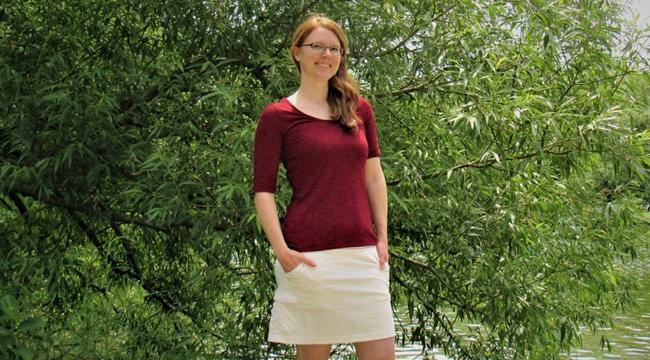 Stem cell donor Rachel Van Pelt stands in front of a green tree by a lake.