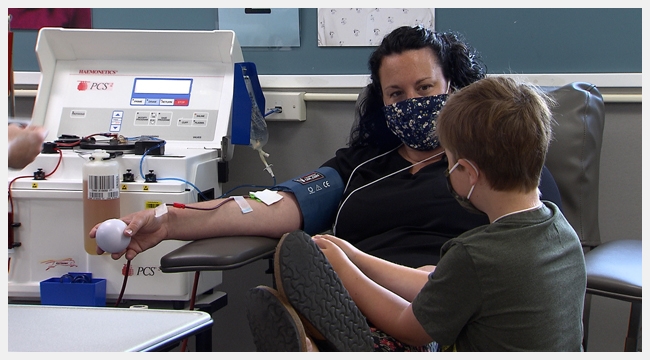 Shannon Morrison donates plasma while her son Heydan looks at her. Heydan receives medication made from plasma.