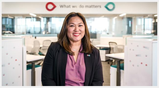 Thumbnail image of close up Territory manager for Calgary, Alberta, Jhoanna Del Rosario sitting in the Workplace of the Future at the new Canadian Blood Service Operational Facility