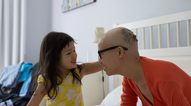 Stem cell recipient and advocate Mai Duong smiles with her daughter  